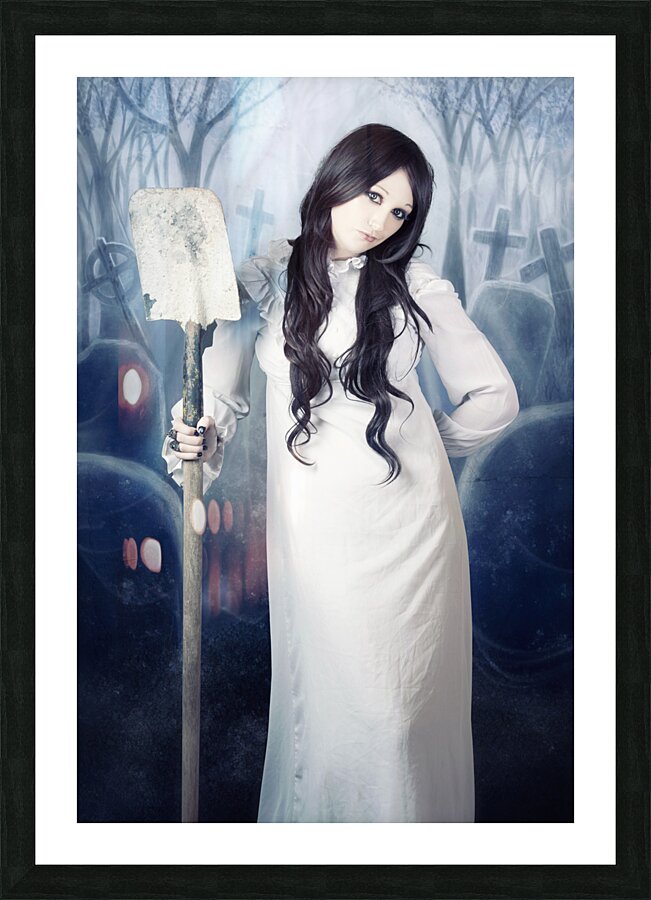 Spooky witch gravedigger with spade in graveyard Picture Frame print