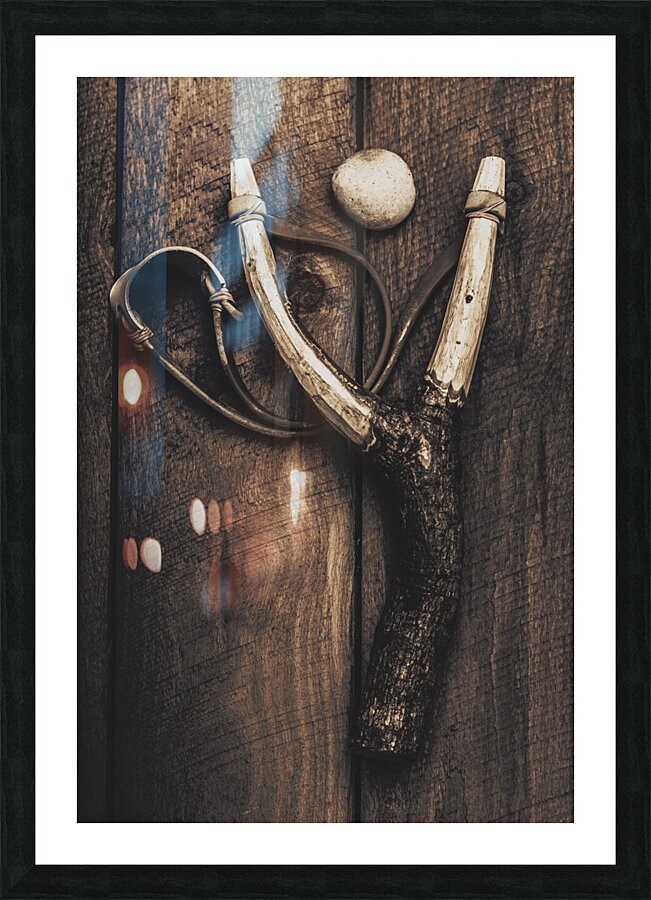 Vintage toy slingshot on wooden cubby house floor Picture Frame print