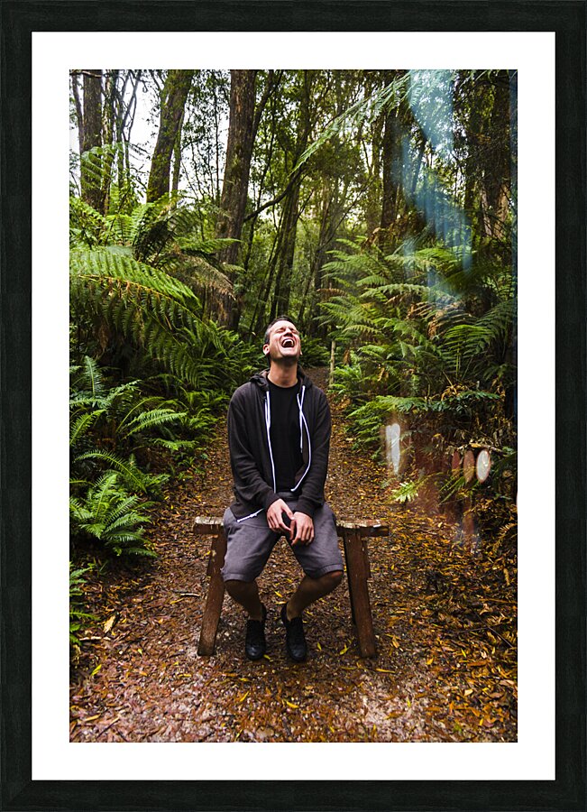 Travel man laughing in Tasmania rainforest Picture Frame print