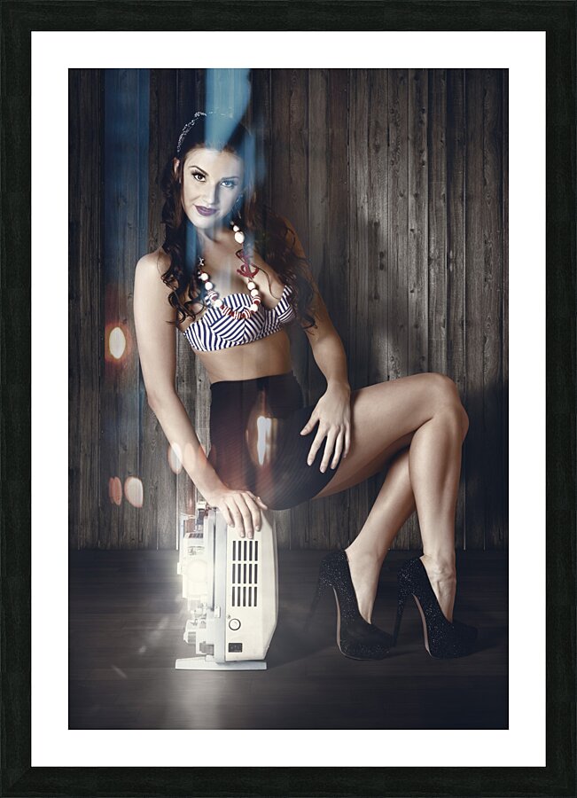 Young brunette pin-up woman on old film projector Picture Frame print