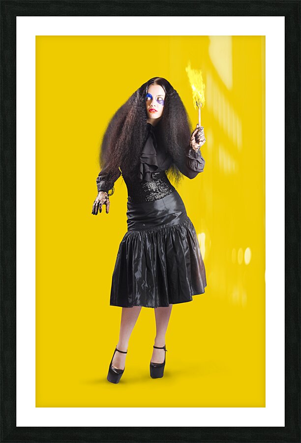 Female jester holding lit fire torch Picture Frame print