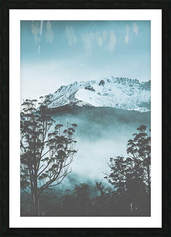Dramatic dark blue mountain with snow and fog Picture Frame print