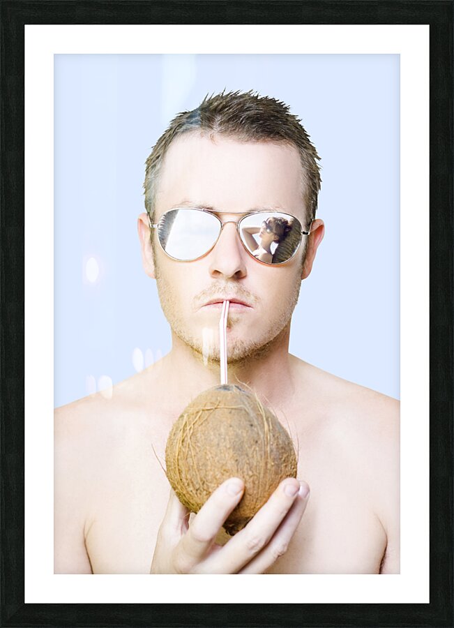 Handsome summer man drinking coconut cocktail Picture Frame print