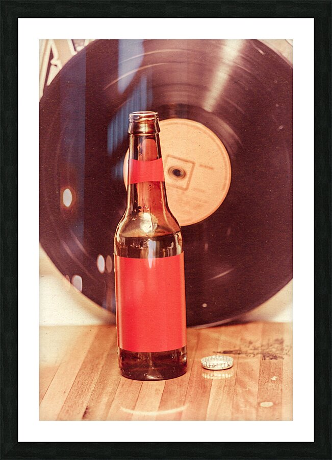 Beer bottle on bar counter top with vinyl record Picture Frame print