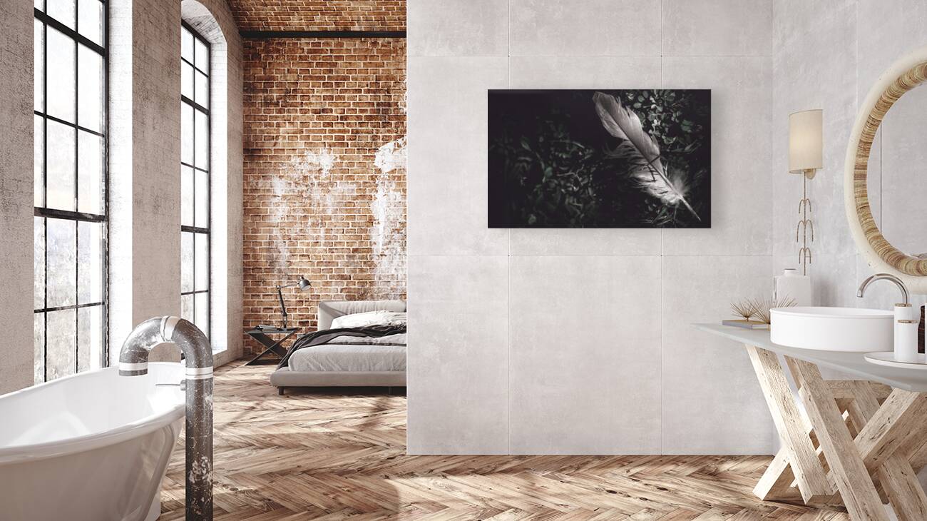 Feather quill lying in green grass. Writers guild  Reproduction