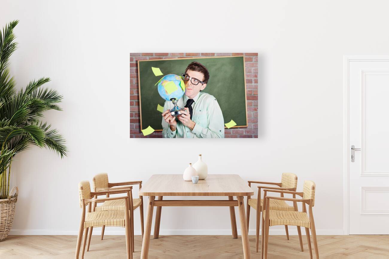 Nerd man holding earth world globe in classroom Reproduction