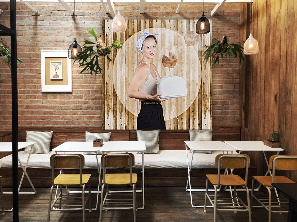 Female breakfast waiter with hot toast in toaster Reproduction