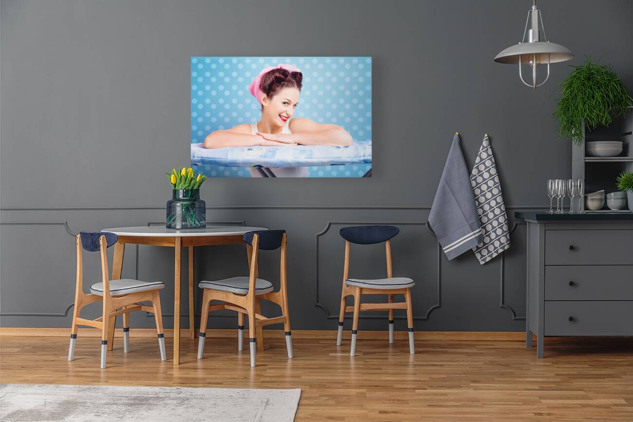 Happy 60s pinup housewife on blue ironing board Reproduction