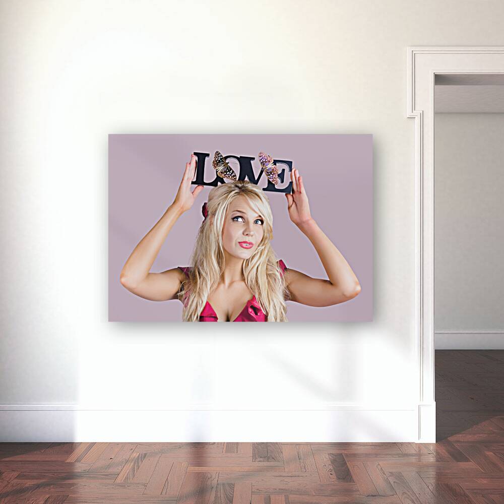 Woman holding love sign Reproduction