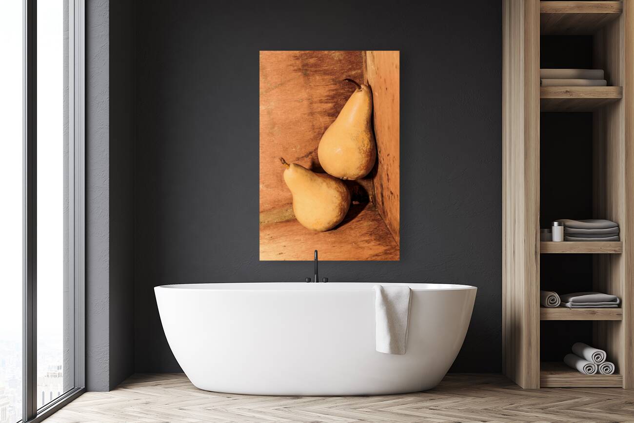 Yellow colored pears on wooden background Reproduction