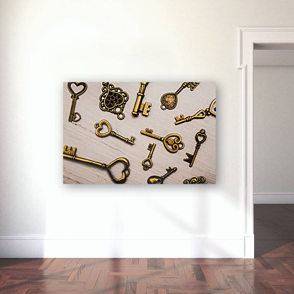 Metal keys of different size on wooden table Reproduction