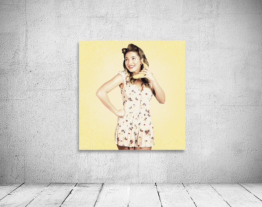 Funny pin-up model in conversation on banana phone Wall Preview