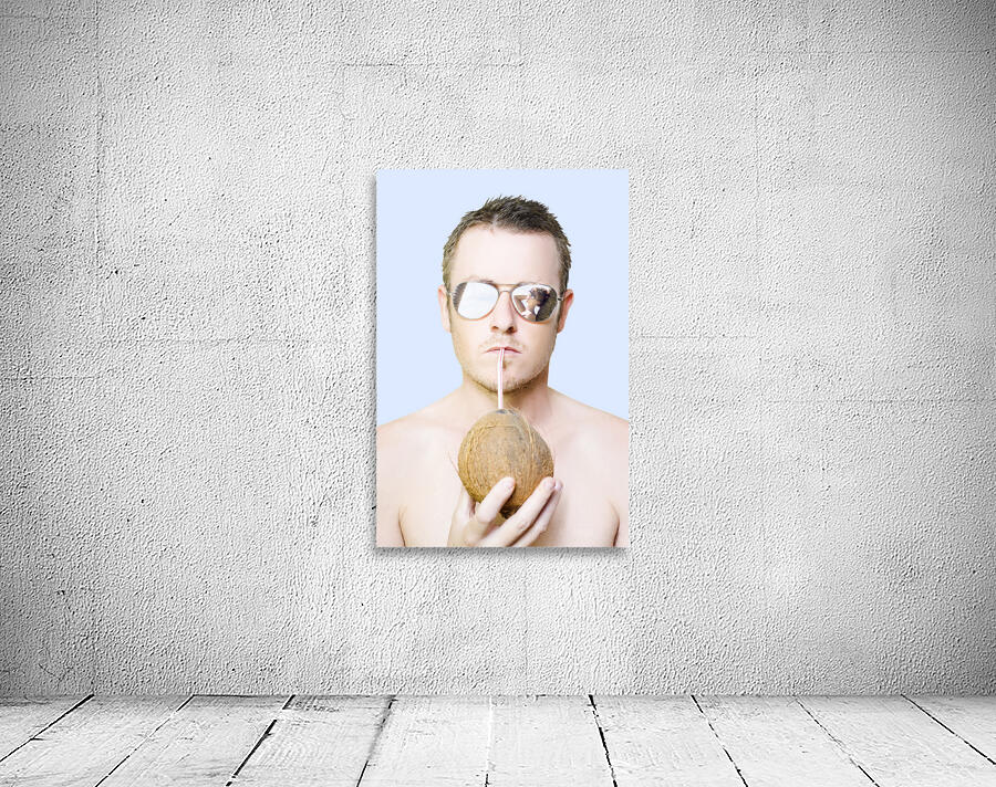 Handsome summer man drinking coconut cocktail Wall Preview
