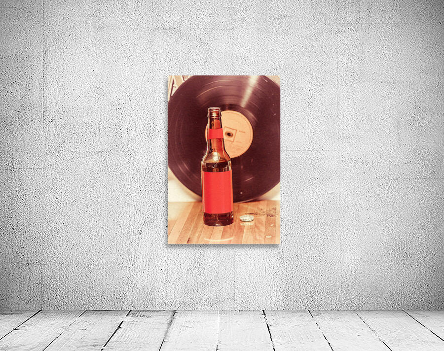 Beer bottle on bar counter top with vinyl record Wall Preview