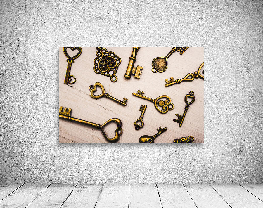 Metal keys of different size on wooden table Wall Preview