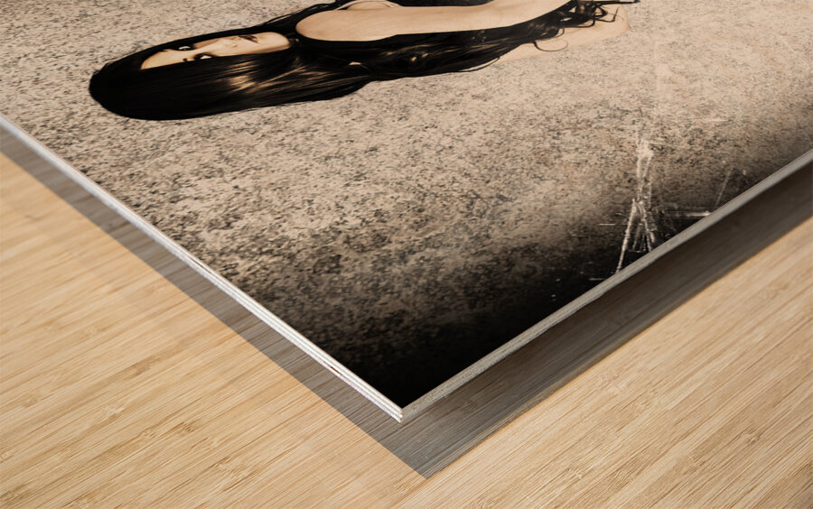 Sexy brunette woman holding gun with deadly style Wood print