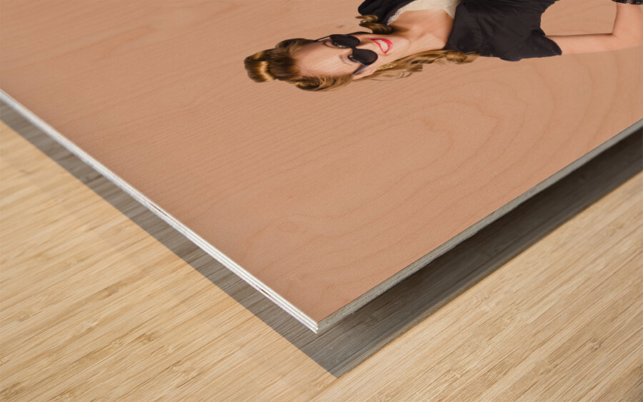 Pin-up seated on a pine trunk Wood print