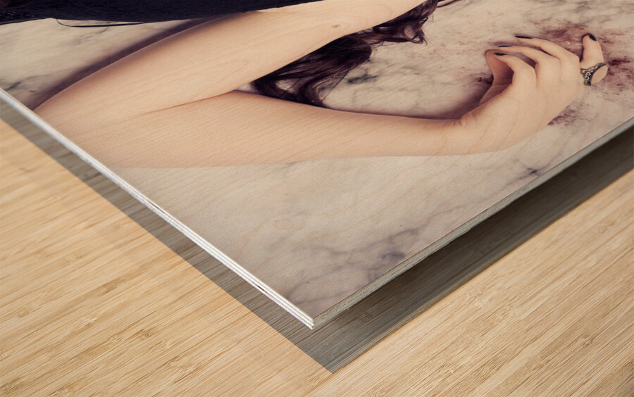 Dead woman holding black flower in blood puddle Wood print