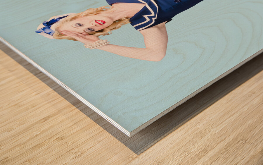 Young retro pinup girl wearing sailor uniform Wood print