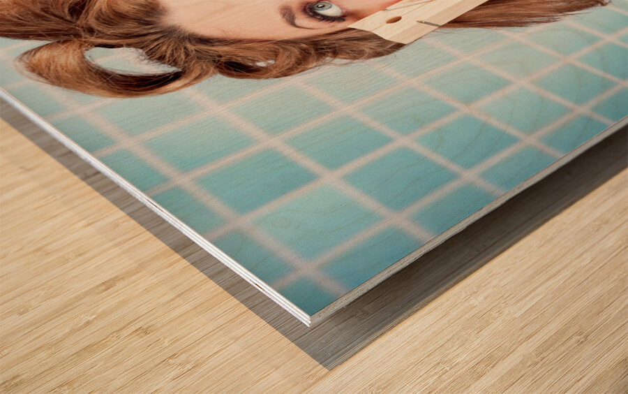 Gorgeous pin-up woman holding large cleaning peg Wood print