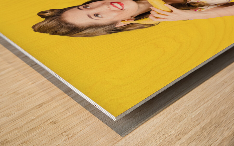Retro pin up girl chatting on banana telephone Wood print