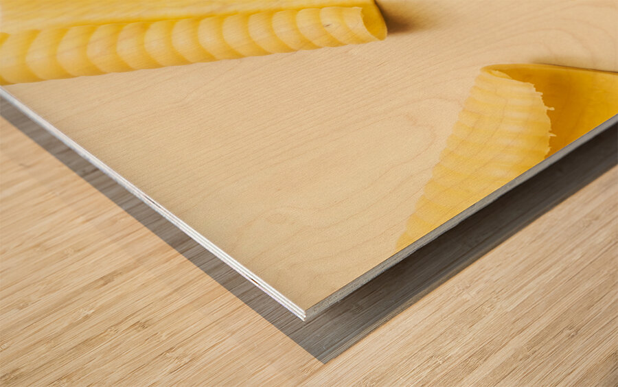 Butter curls on white background Wood print
