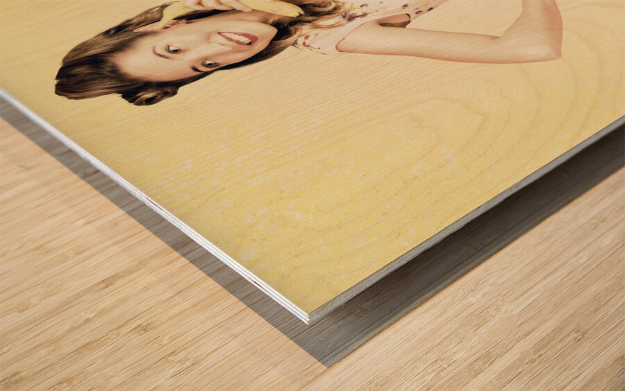 Funny pin-up model in conversation on banana phone Wood print