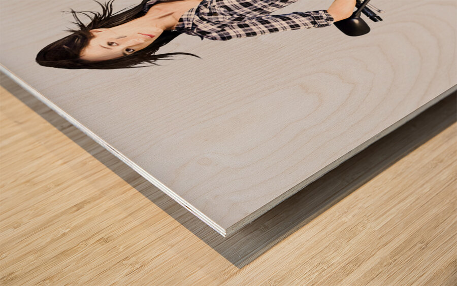 Woman leaning on a motorbike Wood print