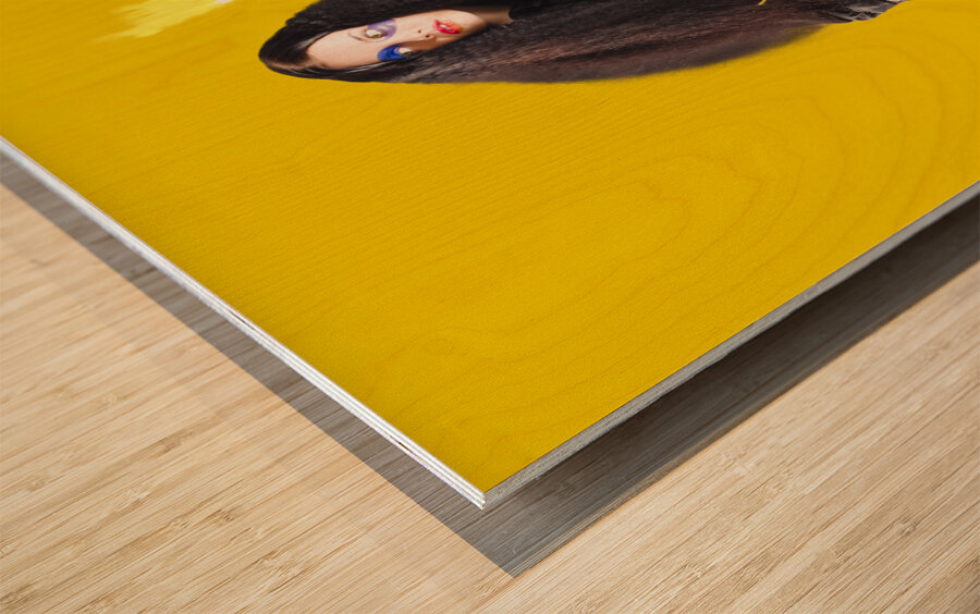 Female jester holding lit fire torch Wood print