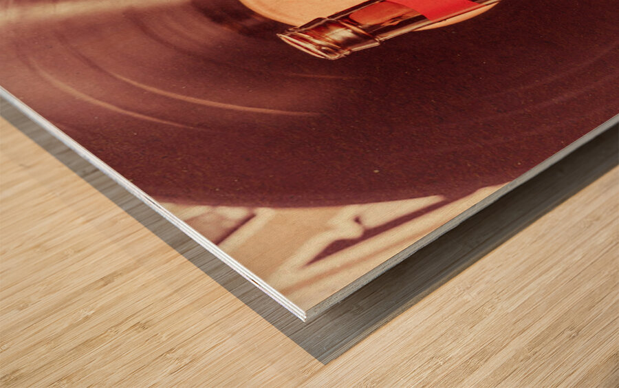 Beer bottle on bar counter top with vinyl record Wood print
