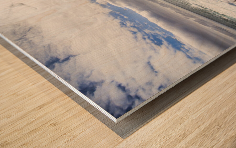 Sun rising over the ocean Wood print