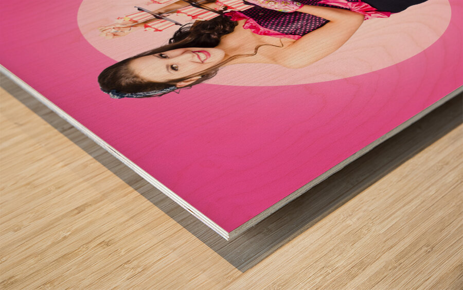 Pin-up girl popping out of large birthday cake Wood print