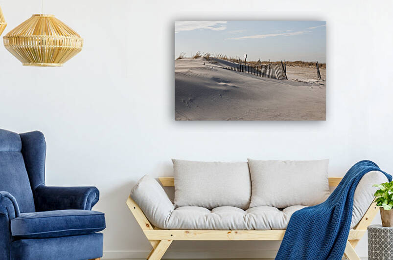 Side view of wind swept sand covering parts of a by Woodys Photos