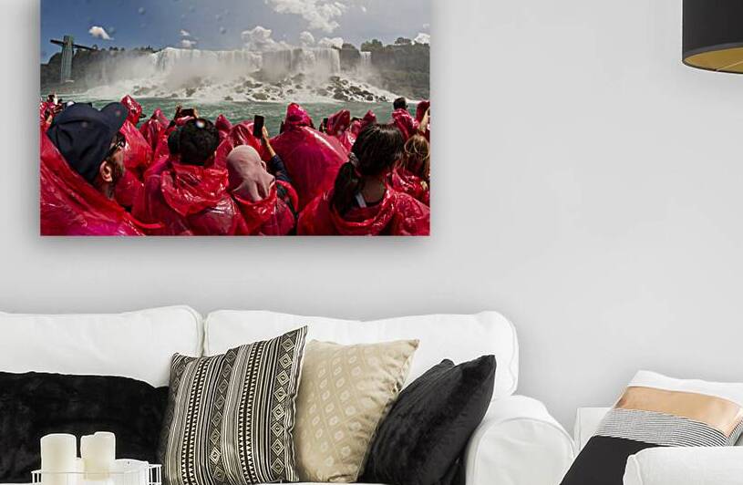 Tourists in red raingear on a tour boat looking a by Woodys Photos