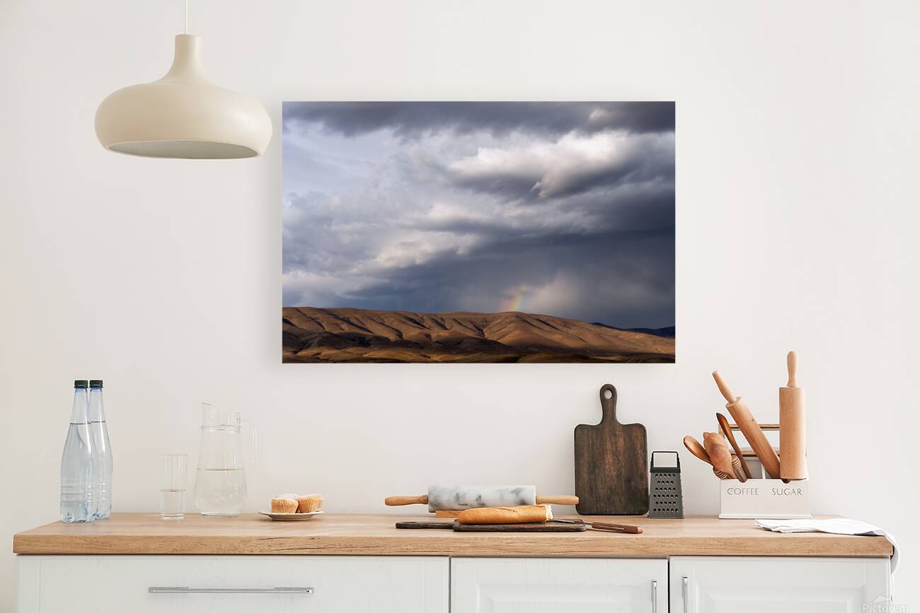 Rainbow with diagonal clouds over morning light on mountains Reproduction