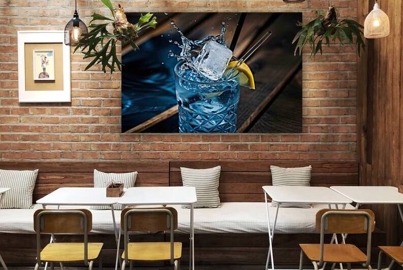 ice cube splashing into a glass full of water .jp by Mirela Poiana