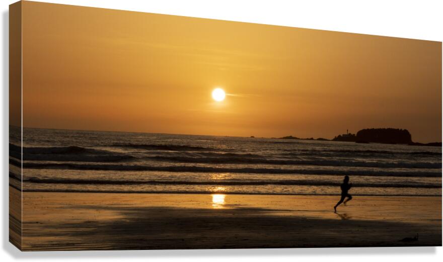 Man running along the beach at sunset  Canvas Print