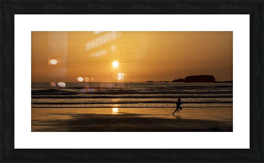 Man running along the beach at sunset  Picture Frame print