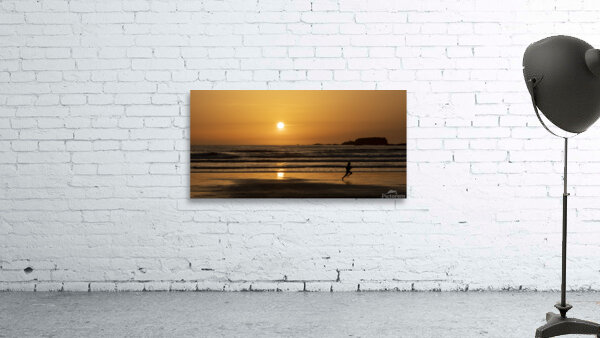 Man running along the beach at sunset  Wall Preview