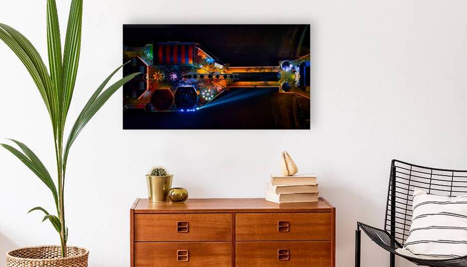 High-angle view of an illuminated open computer case showcasing colorful components and LED lights in Backpool England. by Vasile Jechiu