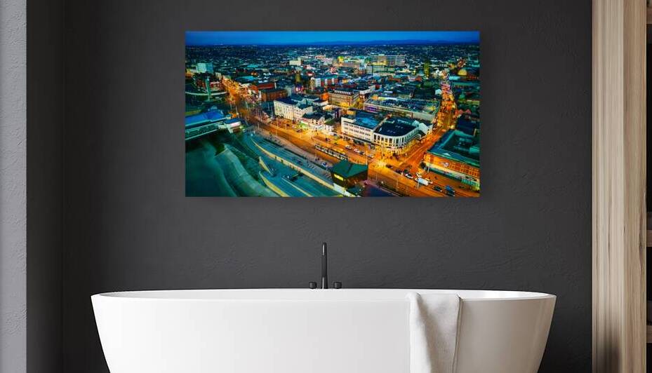 Aerial night view of a vibrant cityscape with illuminated streets and buildings showcasing urban life and architecture in Backpool England. by Vasile Jechiu