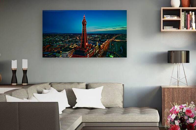 Aerial night view of Blackpool Tower illuminated in red with cityscape and coastline. by Vasile Jechiu