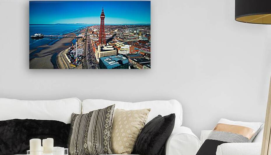 Aerial view of a coastal city with a prominent tower blue skies and a beachfront in Backpool England. by Vasile Jechiu