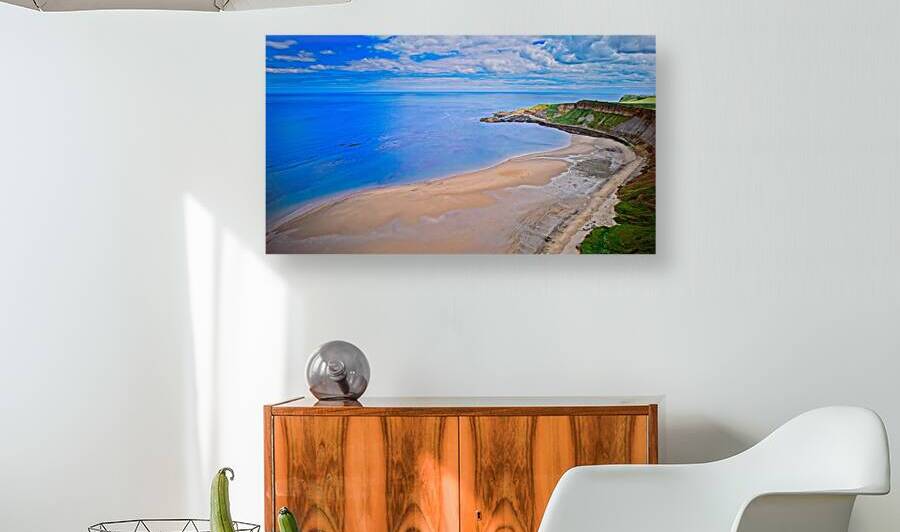 Scenic coastal landscape with sandy beach and green cliffs at Cayton Bay Yorkshire by Vasile Jechiu
