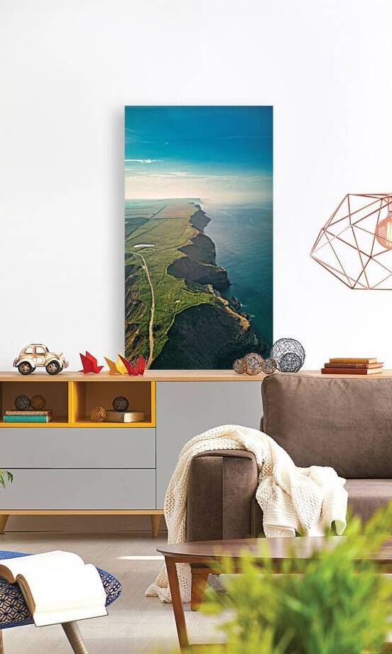 Aerial view of a coastal landscape with cliffs ocean and agricultural fields under a clear sky in Filey England. by Vasile Jechiu