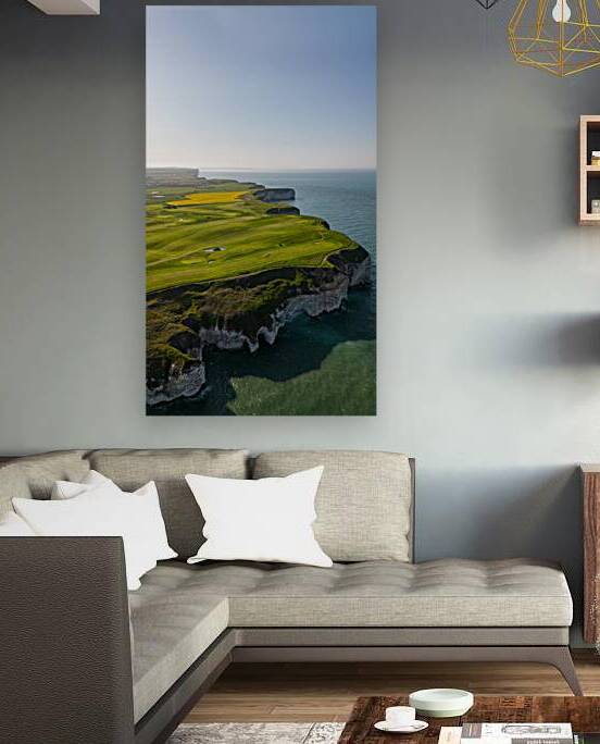 Aerial view of a scenic coastal golf course with lush green fairways and rugged cliffs overlooking a calm blue sea in Flamborough England by Vasile Jechiu
