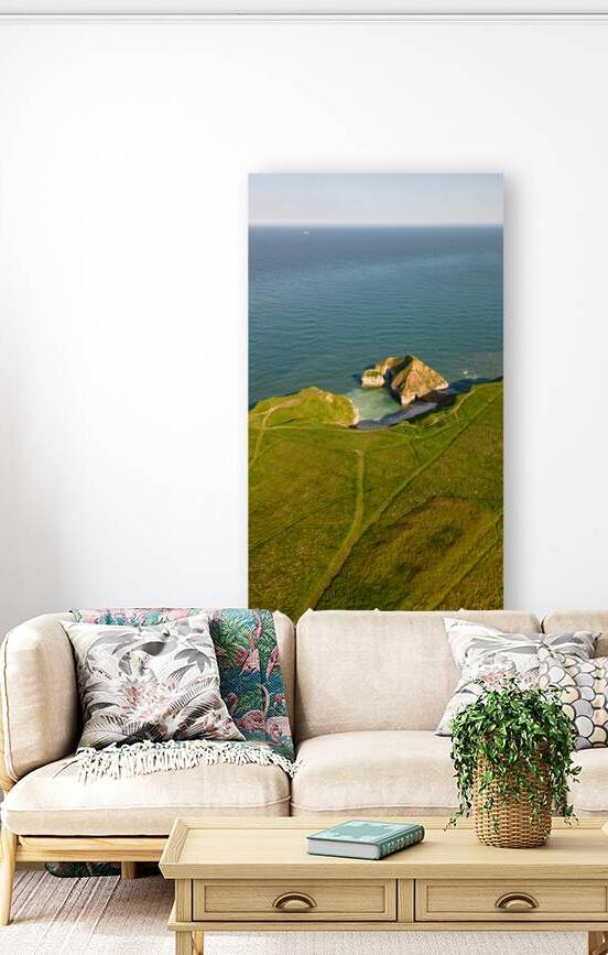 Aerial view of a lush green coastal landscape with cliffs overlooking a serene blue sea in Flamborough England by Vasile Jechiu