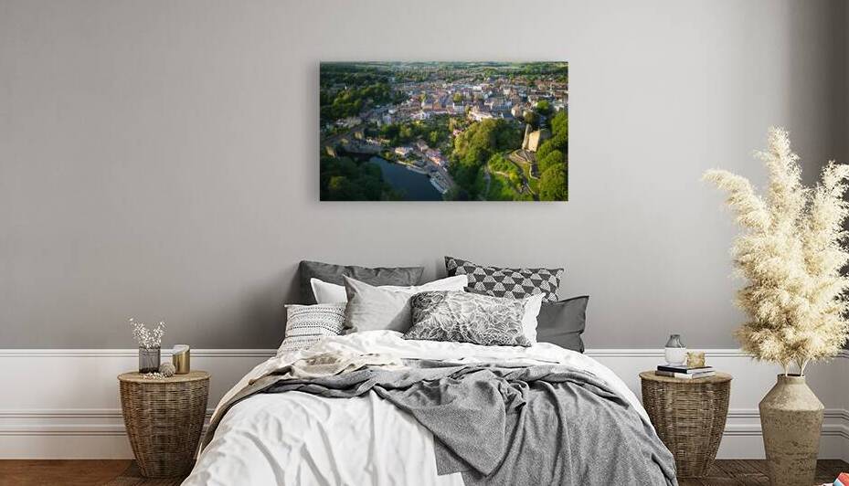 Aerial view of a quaint European town at sunset with historic buildings a river and lush greenery Aerial view of a historic town with an ancient tower surrounded by lush green trees under a clear blue sky in Knaresborough North Yorkshire. by Vasile Jechiu
