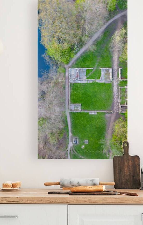 Aerial view of a park with a winding path and green grass adjacent to a body of water in Knaresborough North Yorkshire. by Vasile Jechiu