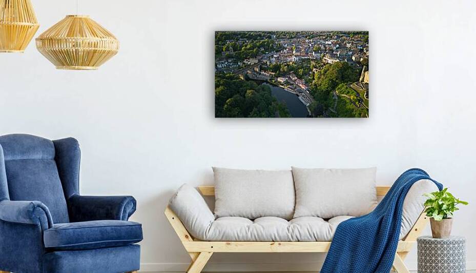 Aerial view of a quaint town with historic buildings alongside a river surrounded by lush greenery at dusk Aerial view of a historic town with an ancient tower surrounded by lush green trees under a clear blue sky in Knaresborough North Yorkshire. by Vasile Jechiu